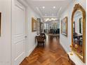 Long hallway features artwork, mirrors, and hardwood flooring at 2211 E Camelback Rd # 902, Phoenix, AZ 85016