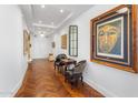 Hallway with hardwood floors, ornate seating and framed art at 2211 E Camelback Rd # 902, Phoenix, AZ 85016