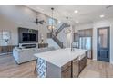 Bright, open-concept living space with high ceilings, fireplace and seamless transition to kitchen at 22771 N 98Th Dr, Peoria, AZ 85383