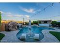 Resort-style pool with a waterfall feature, a swim-up bar, and comfortable lounging area at 22771 N 98Th Dr, Peoria, AZ 85383