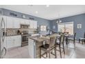 Bright kitchen featuring granite countertops, stainless steel appliances, and a cozy breakfast nook with a view at 2322 E Mews Rd, Gilbert, AZ 85298