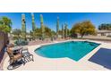 Sparkling pool with desert landscaping, diving board, and privacy fence at 25606 W Satellite Ln, Buckeye, AZ 85326
