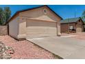 Beige single-story home featuring a two-car garage, desert landscaping, and a new roof at 2906 W Irma Ln, Phoenix, AZ 85027