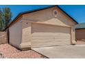 Beige single-story home featuring a two-car garage, desert landscaping, and a new roof at 2906 W Irma Ln, Phoenix, AZ 85027