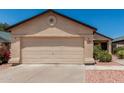 Beige single-story home featuring a two-car garage, desert landscaping, and a new roof at 2906 W Irma Ln, Phoenix, AZ 85027