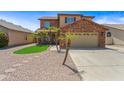 A two-story suburban residence with desert landscaping and a paved driveway at 2909 W Bowker St, Phoenix, AZ 85041
