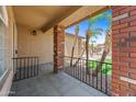Covered front porch with tile flooring and brick support columns at 2909 W Bowker St, Phoenix, AZ 85041
