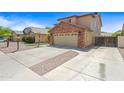 Suburban house featuring an attached two-car garage and concrete driveway at 2909 W Bowker St, Phoenix, AZ 85041