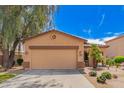 Charming single-story home features a two-car garage and professionally landscaped front yard at 30266 N Royal Oak Way, San Tan Valley, AZ 85143