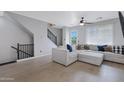 Spacious living room with hardwood floors, large sectional sofa, and staircase with black railings at 3687 E Leslie Dr, Gilbert, AZ 85296