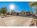 A home boasting a spacious driveway, desert landscaping, and a porte-cochère at 3710 E Mercer Ln, Phoenix, AZ 85028