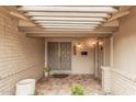 Welcoming front porch featuring tiled flooring, a brick wall, and double doors at 3710 E Mercer Ln, Phoenix, AZ 85028