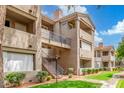 View of an apartment building exterior showing staircases, balconies, and tiled roof at 3830 E Lakewood Pkwy # 3099, Phoenix, AZ 85048