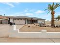 Inviting single-story home showcasing a well-maintained yard with desert landscaping and a tall palm tree at 3973 W Hearn Rd, Phoenix, AZ 85053