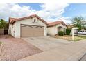 Charming home featuring a two-car garage, desert landscaping, and a cozy, inviting facade at 510 W Amoroso Dr, Gilbert, AZ 85233