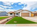 Inviting single-story home featuring manicured artificial lawn and a two-car garage at 524 S Pioneer --, Mesa, AZ 85204
