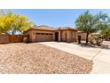 Well-maintained single-story home with a two-car garage and xeriscaping at 5401 S Dove Holw, Buckeye, AZ 85326