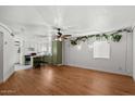 Open-concept living room with wood flooring, lots of light and adjacent kitchen at 6236 N 16Th St # 1, Phoenix, AZ 85016