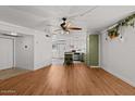 Open-concept living room with wood flooring, lots of light and adjacent kitchen at 6236 N 16Th St # 1, Phoenix, AZ 85016