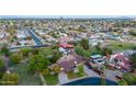 Expansive aerial view showcasing the neighborhood's mature trees, swimming pools, and a mix of home styles at 645 S Esquire Way, Mesa, AZ 85202