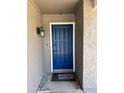 Inviting front door featuring a blue door, white trim, updated light fixture, and 'Home' welcome mat at 822 W El Alba Way, Chandler, AZ 85225