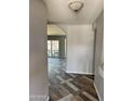 Hallway featuring decorative flooring and leading into an open floor plan with an archway and patio door at 822 W El Alba Way, Chandler, AZ 85225