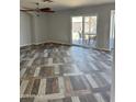 Open living room area boasting decorative flooring, ceiling fan, and a sliding glass door to the outside patio at 822 W El Alba Way, Chandler, AZ 85225