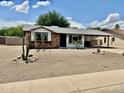 Charming single-story home with a covered carport and low maintenance desert landscaping at 8402 N 105Th Ln, Peoria, AZ 85345