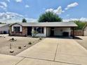 Charming single-story home with a covered carport and low maintenance desert landscaping at 8402 N 105Th Ln, Peoria, AZ 85345