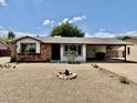 Charming single-story home with a covered carport and low maintenance desert landscaping at 8402 N 105Th Ln, Peoria, AZ 85345