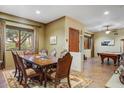 Elegant dining room with a large wooden table, decorative rug, and a view to a billiards room at 8526 E Hackamore Dr, Scottsdale, AZ 85255