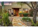 Inviting single-story home with well-maintained landscaping and a stone walkway leading to the front door at 8526 E Hackamore Dr, Scottsdale, AZ 85255