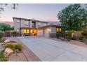 Spacious home with a three-car garage, desert landscaping, and a welcoming front porch at 9231 W Bent Tree Dr, Peoria, AZ 85383