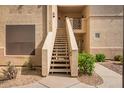 Exterior stairway leading to units with desert landscaping surrounding the walkway at 9550 E Thunderbird Rd # 259, Scottsdale, AZ 85260