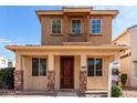 Charming two-story home featuring a cozy front porch and a small balcony on the second floor at 10055 E Isabella Ave, Mesa, AZ 85209