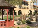 Beautiful gardens and walkways near the building, showcasing manicured landscaping and charming structures at 10330 W Thunderbird W Blvd # B103, Sun City, AZ 85351