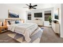 Comfortable main bedroom with a king bed, soft rug and lots of natural light at 1078 E Poncho Ln, San Tan Valley, AZ 85143