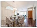 Bright dining area featuring a glass table, stylish chandelier, and modern decor at 11034 W Sierra Pinta Dr, Peoria, AZ 85373