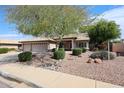 Inviting single-level home with a three-car garage and low maintenance desert landscape at 11034 W Sierra Pinta Dr, Peoria, AZ 85373