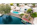 This waterfront property offers a private pool, boat dock, and outdoor living space for relaxing or entertaining at 1146 W Sea Fog Dr, Gilbert, AZ 85233