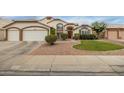 Well-maintained house showcasing a manicured front lawn, desert landscaping, and a two-car garage at 1146 W Sea Fog Dr, Gilbert, AZ 85233