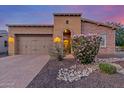 Charming single-Gathering home with a well-manicured front yard and a two-car garage at 1260 E Sweet Citrus Dr, Queen Creek, AZ 85140