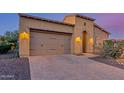 Beautiful home featuring a paved driveway, two-car garage, and desert landscaping at 1260 E Sweet Citrus Dr, Queen Creek, AZ 85140