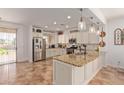Stylish kitchen with granite countertops, stainless steel appliances, a central island, and decorative pendant lighting at 1277 W Stephanie Ln, San Tan Valley, AZ 85143