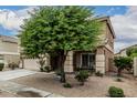 Charming two-story home featuring a well-manicured lawn, a two-car garage, and a welcoming entryway at 14318 N 142Nd Ln, Surprise, AZ 85379