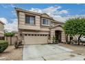 Charming two-story home featuring a well-manicured lawn, a two-car garage, and a welcoming entryway at 14318 N 142Nd Ln, Surprise, AZ 85379