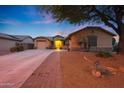 Attractive single-story home featuring a well-maintained lawn and a brick-lined walkway to the entrance at 15245 W Crocus Dr, Surprise, AZ 85379