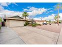 Charming single-story home featuring well-kept landscaping, a two-car garage and long driveway at 15424 N 52Nd Pl, Scottsdale, AZ 85254