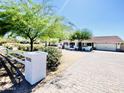 Charming home exterior featuring a well-manicured lawn, mature trees, and a lovely driveway at 15602 N 37Th St, Phoenix, AZ 85032