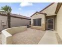Front yard featuring desert landscaping and a private front patio with paved brick flooring at 15822 W Alpine Ridge Dr, Surprise, AZ 85374
